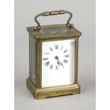 Travel clock, brass, circa 1900, faceted on all sides, top handle, with white dial and black Roman