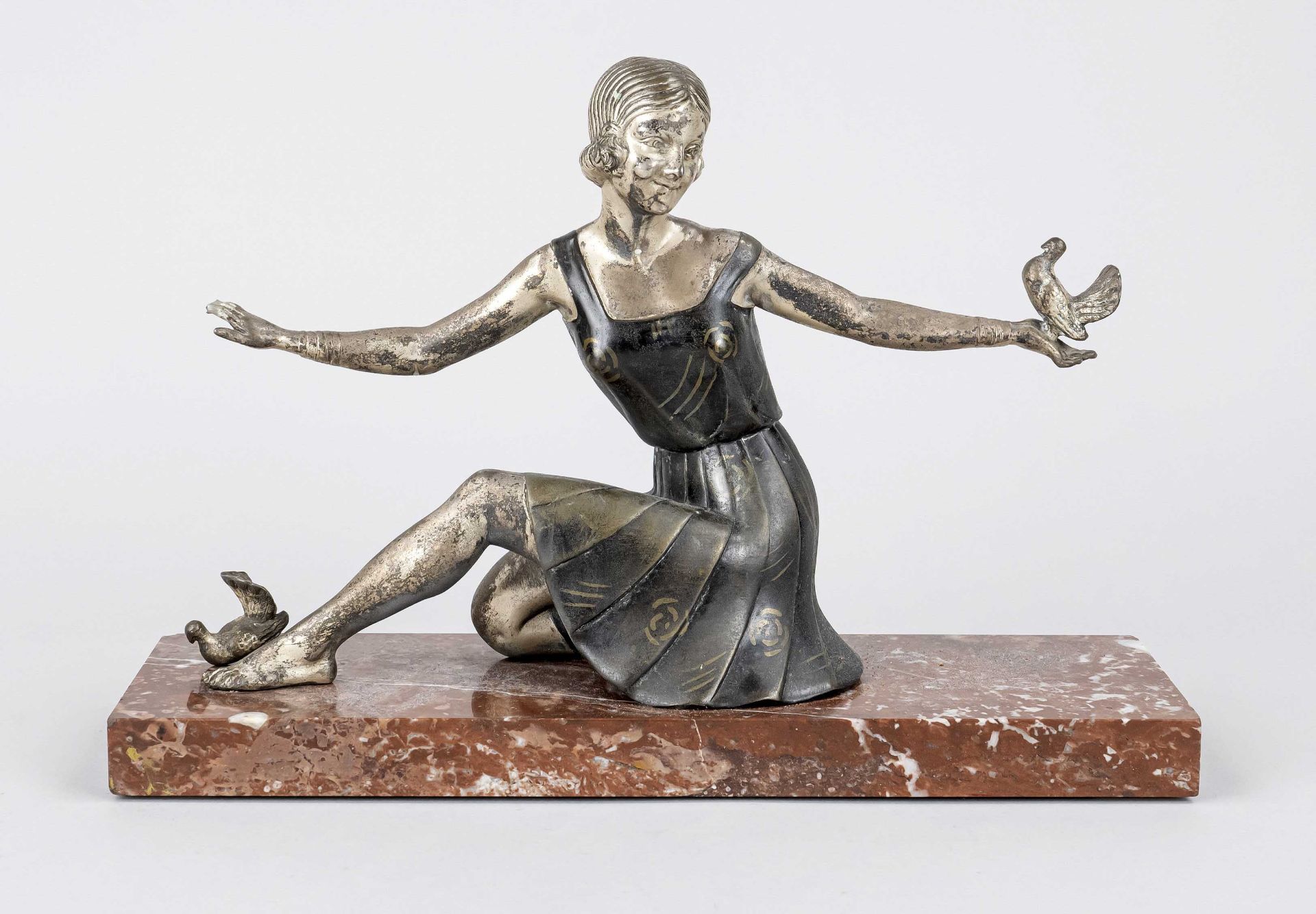 Art Déco figure, c. 1920, seated girl with outstretched arms and doves on her hands (one burnt off),