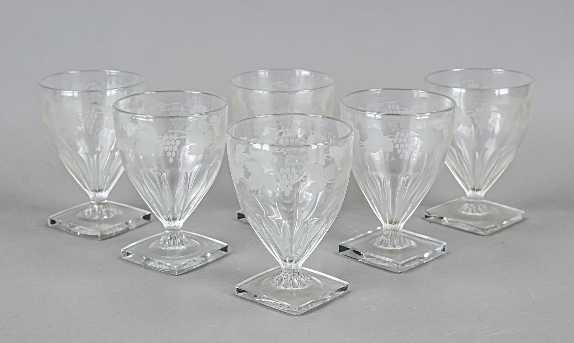 Six wine goblets, early 20th century, square base, short stem merging into a tulip-shaped bowl,