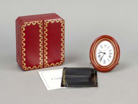 Cartier table clock brass gilt with red enamel rim, from 1978, white dial with black Roman numerals,