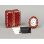 Cartier table clock brass gilt with red enamel rim, from 1978, white dial with black Roman numerals,