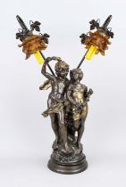 Figural lamp, 20th century, bronzed mass casting. Enraptured couple on a terrain plinth. Lamps as