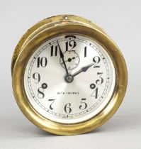Polished and lacquered brass ship's clock, marked Seth Thomas, silvered dial with black Arabic