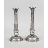 Pair of candlesticks, circa 1900, silver tested, round stand, column shaft, wall with relief