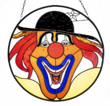 Stained glass with clown, 20th century in round frame with chain suspension, d. 57 cm