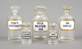 5 apothecary standing vessels, late 19th century, glass with label painting/print with gold rim,