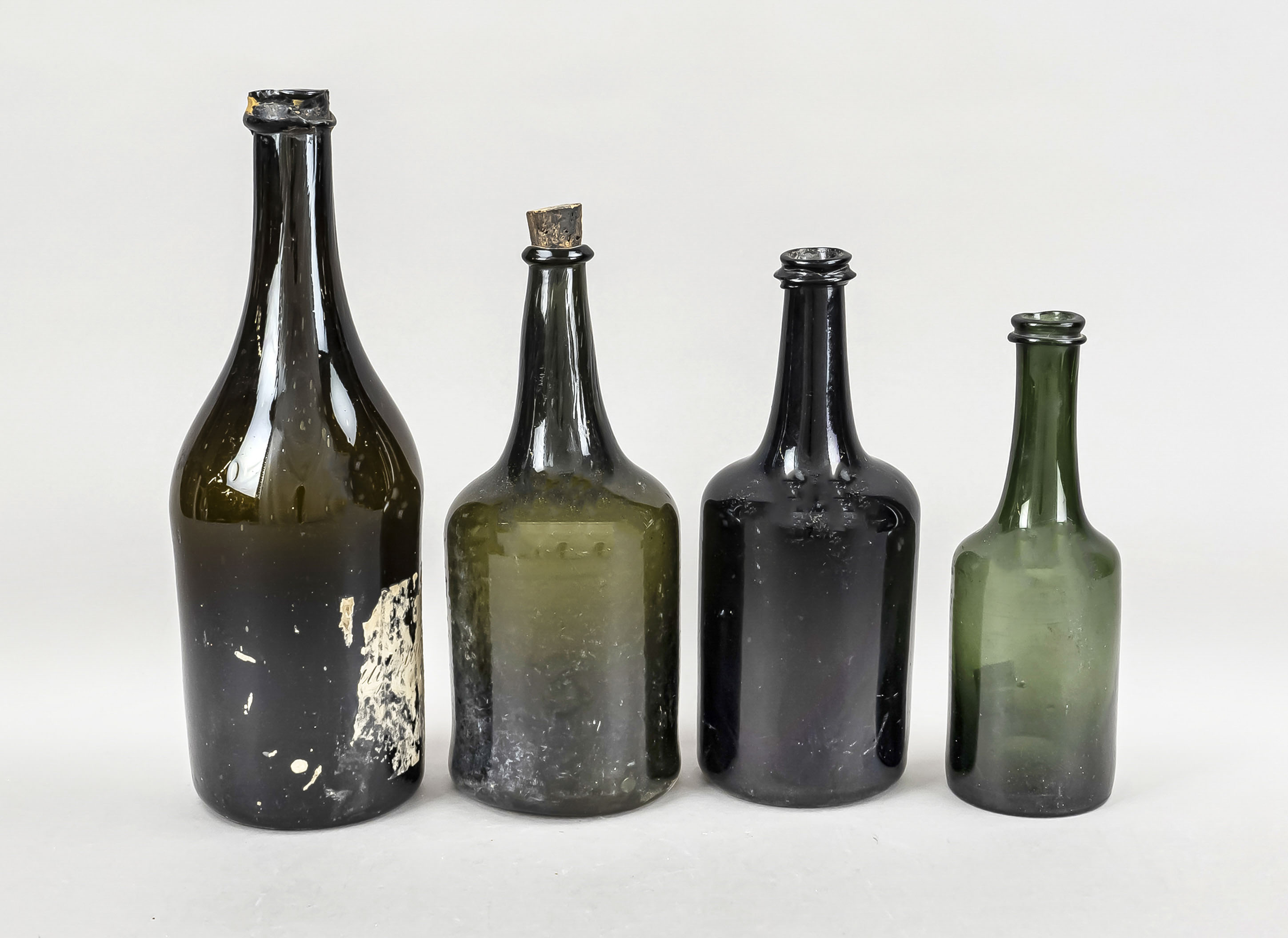 Four wine bottles, 19th century, each of cylindrical form with slender neck, each with differently