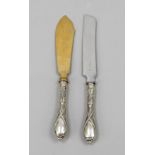 Two Art Nouveau serving knives, German, early 20th century, silver 800/000, with floral relief