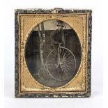 Daguerreotype, 2nd half 19th century Man on penny-farthing, leaning against a tree, oval framed,