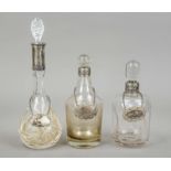 Three carafes, with silver neck mount, 20th century, silver of various finenesses, each with