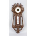 Art Nouveau wall barometer with thermometer, c. 1900, walnut, florally carved, h. 49 cm