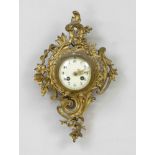 Cartel clock, 2nd half 19th century, gilt brass, decorated with bows and flowers, champagne-