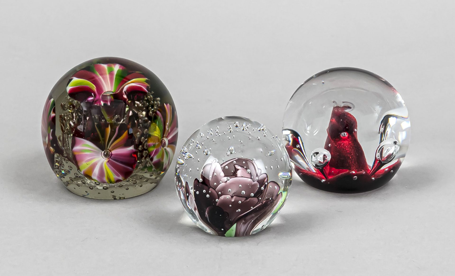 Three paperweights, 20th century, including Scotland, each spherical, clear glass with polychrome