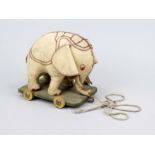 Historical toy as an elephant on wheels, early 20th century, rubbed & bumped, 24 x 28 x 17 cm