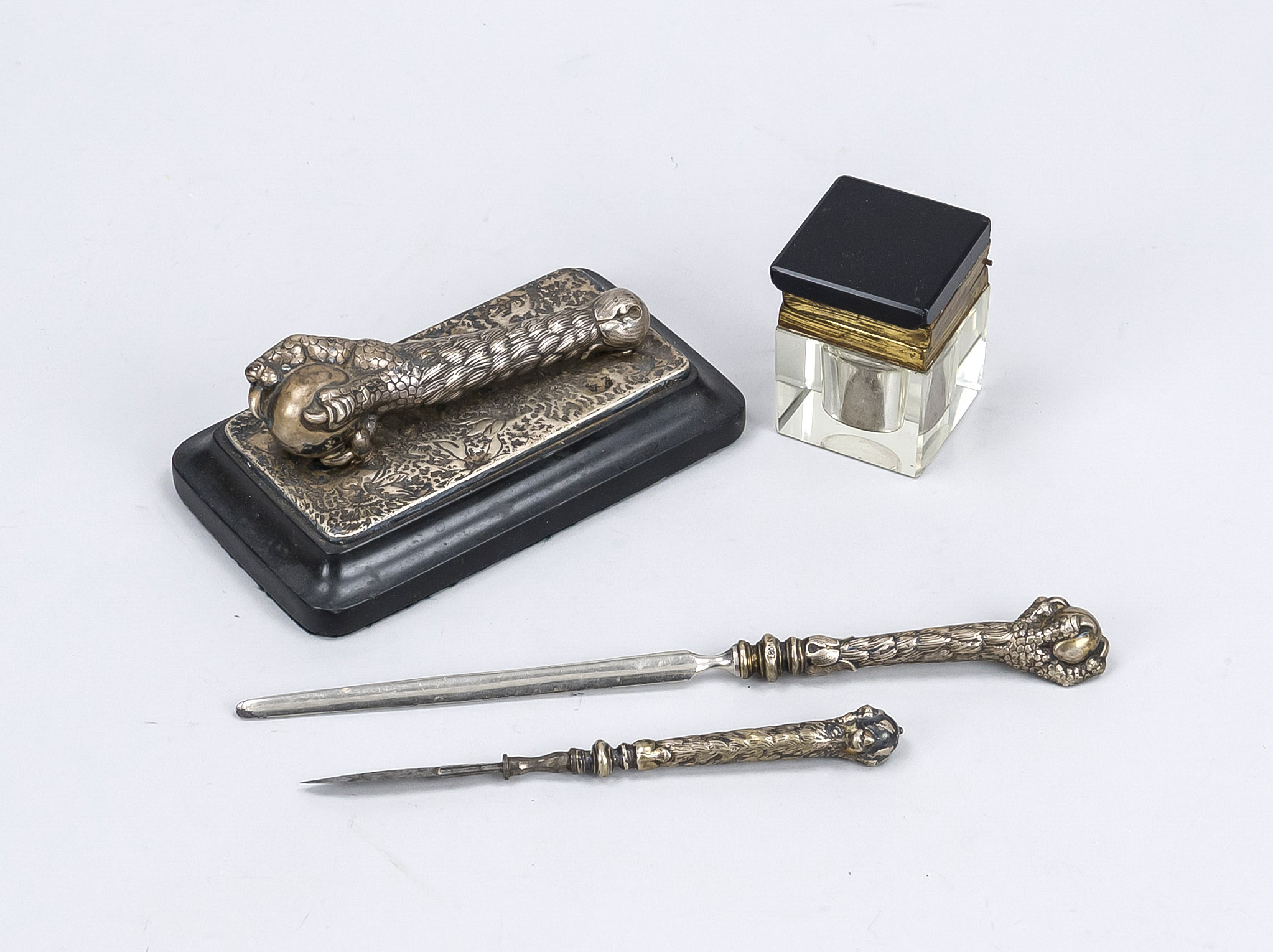 Desk utensils, late 19th century, silver paperweight (stamped 800) on black polished stone, a bird's