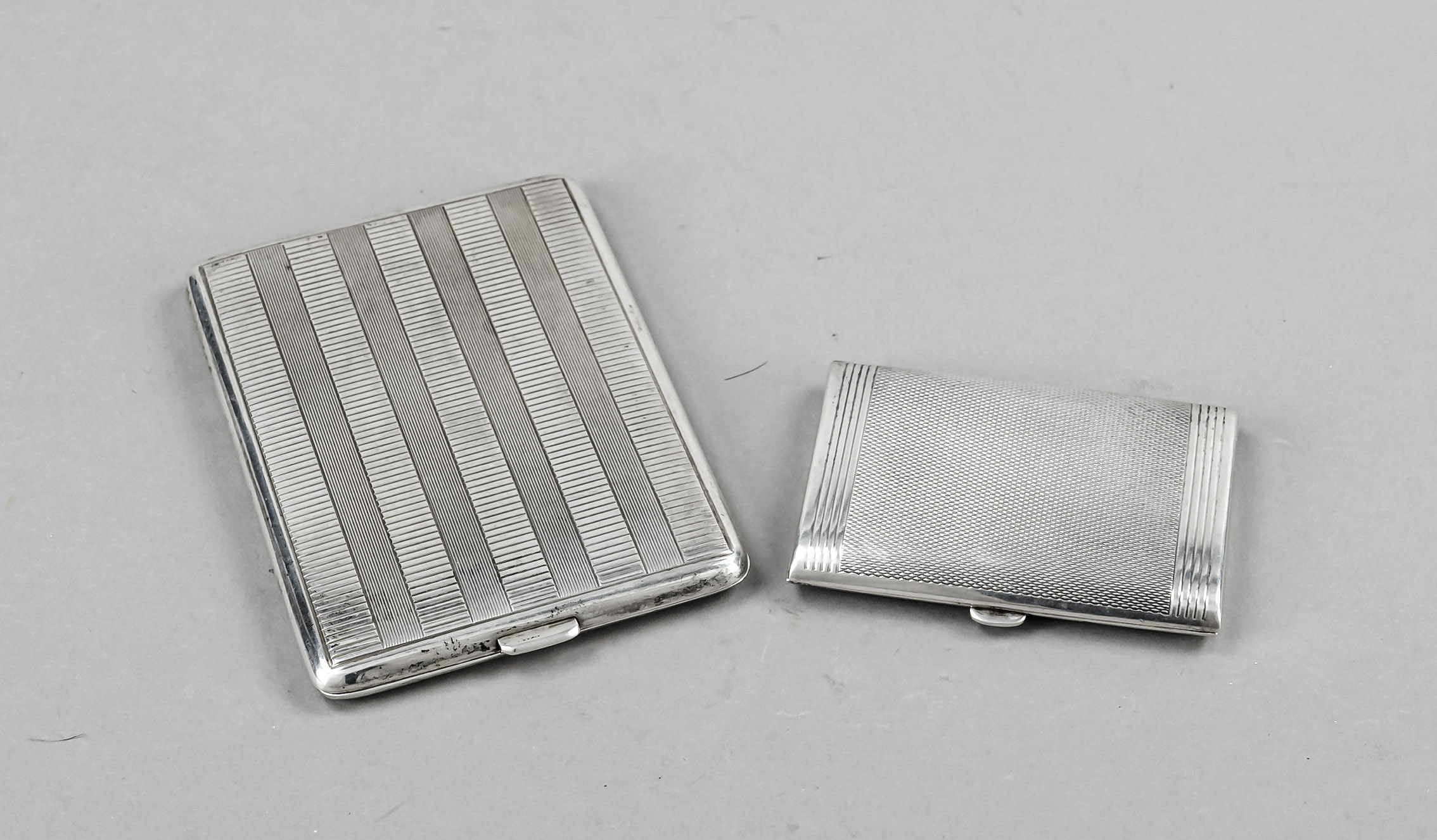 Two rectangular cigarette cases, 1st half 20th century, silver 830/000 and 835/000, each with gilt
