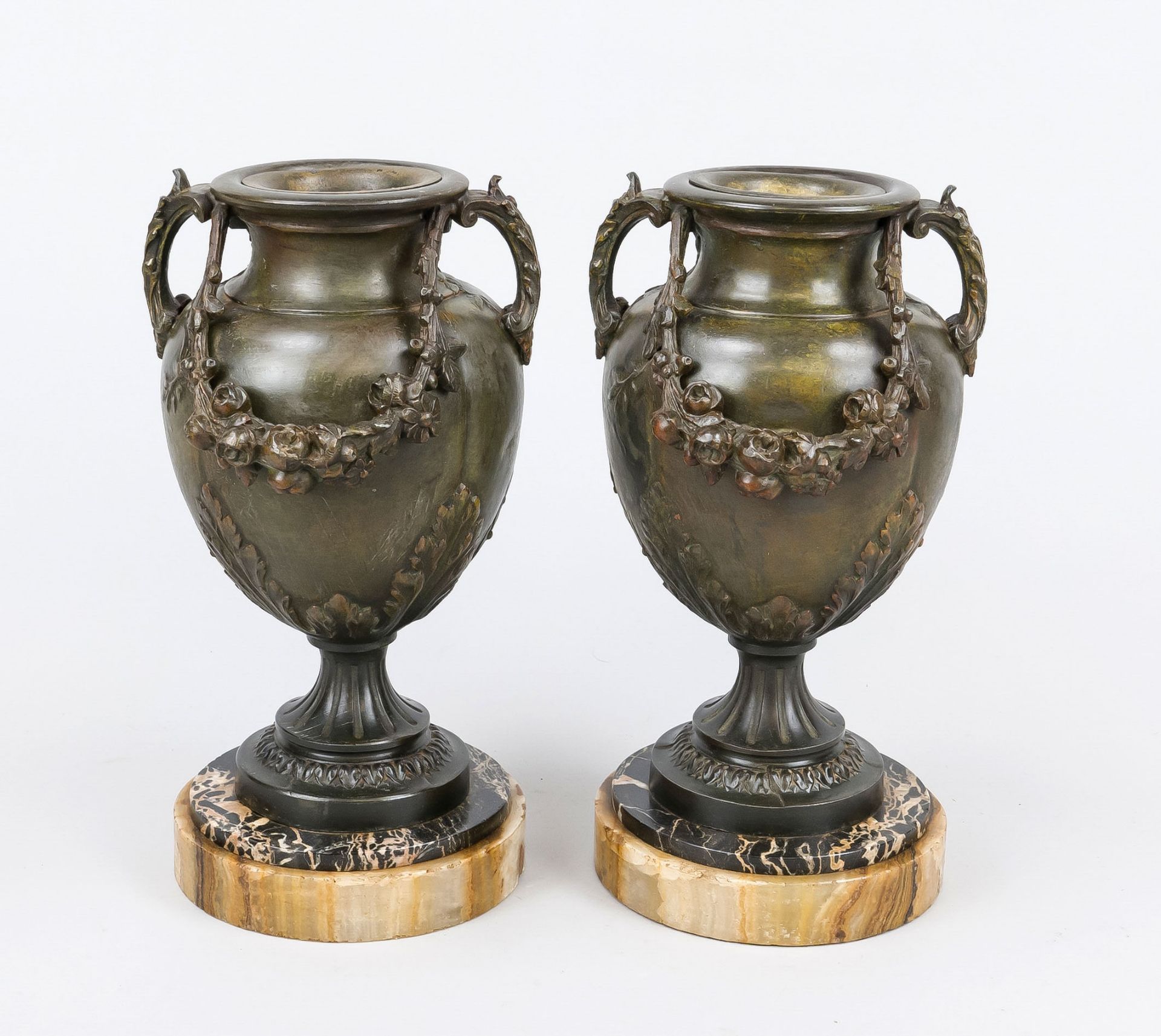 Pair of side plates, late 19th century, bronzed cast metal on a stone base. Vases with relief
