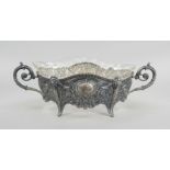 Jardinere, c. 1900, silver tested, on 4 feet, curved body with attached decorated volute handles,