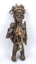 Fetish figure of the Senufo, Ivory Coast, 20th century, dark hardwood, textile, feathers...stress