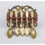 Traditional spoon board, c. 1900, carved wood and florally painted, with 6 brass spoons, l. 25 cm
