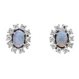 Opal-sapphire ear studs WG 585/000 with 2 oval opal cabochons 6 x 4 mm translucent with good to