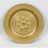 A basin bowl, Germany (Nuremberg?) 16th century, chased brass, flanged rim, the mirror with floral