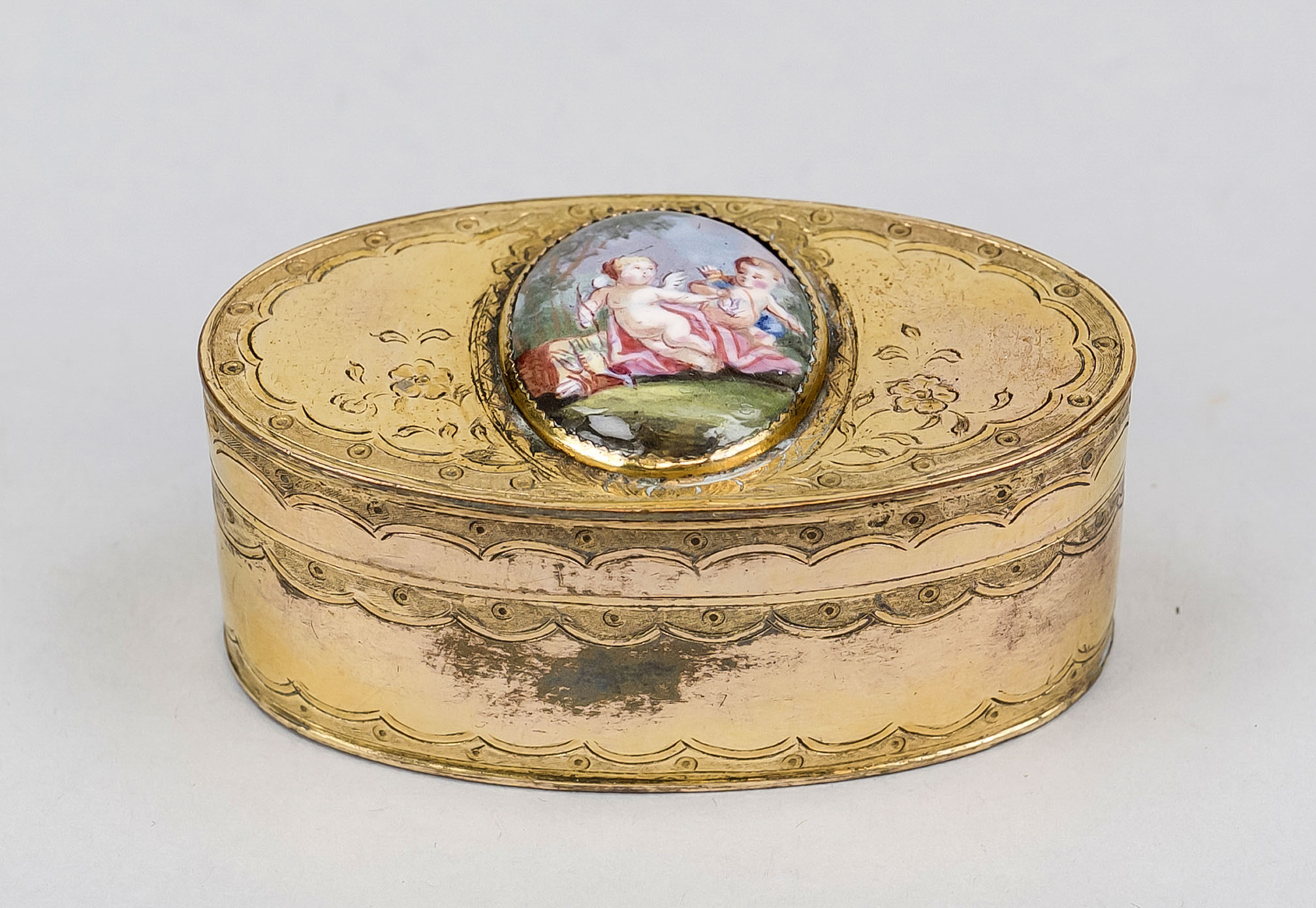 Small lidded box, 19th century, brass with residual gilding. Oval body with hinged lid, the lid