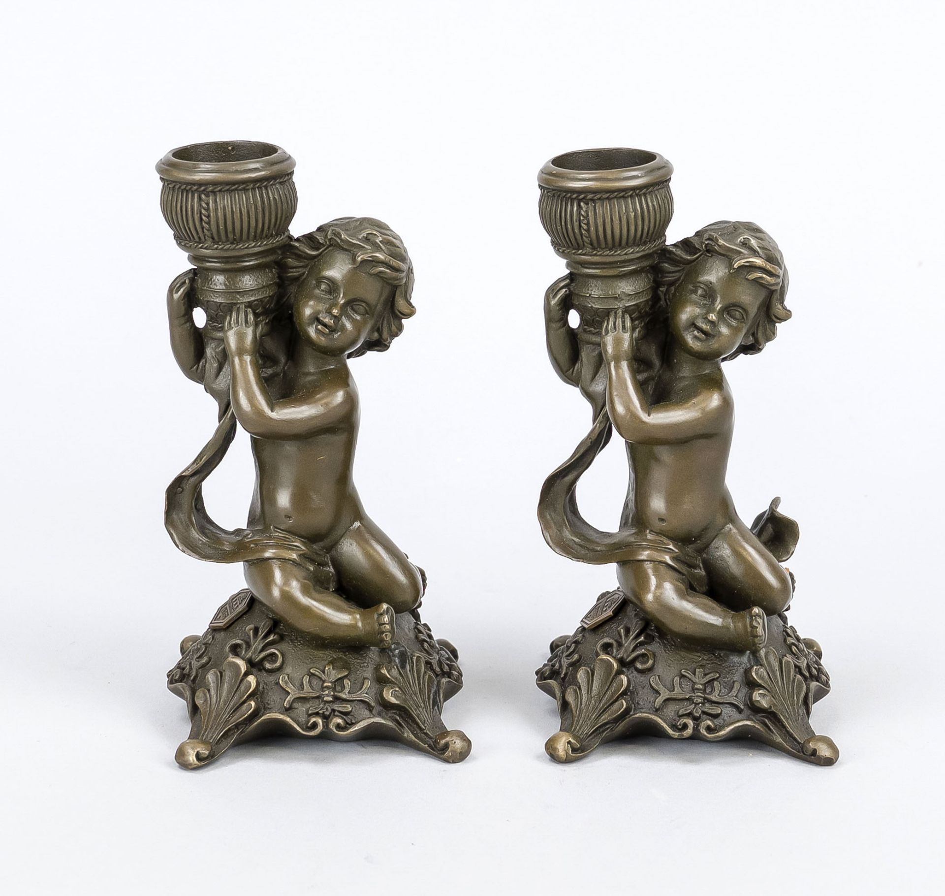 Two figural candle lamps, 20th century, patinated cast bronze, putto carrying the spout, h. 14 cm