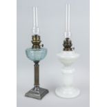 Two kerosene lamps, c. 1900, milk and green glass with metal mount, total h. 63 cm