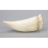 A very large whale's tooth, probably a sperm whale, carved on the lower edge, a circumferential band