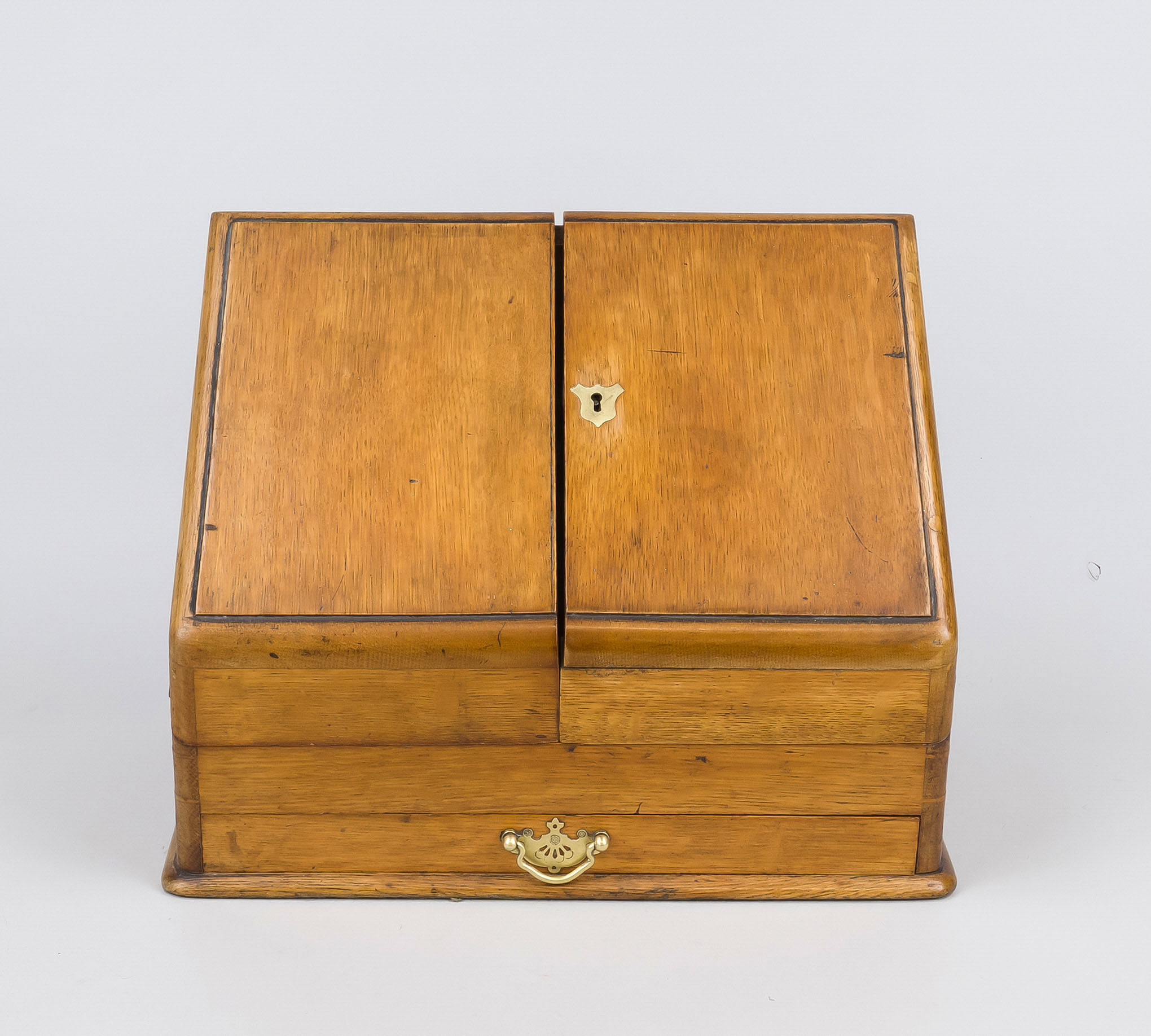 Travel secretary, late 19th century, oak body with brass fittings. Sloping front with hinged door,