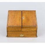 Travel secretary, late 19th century, oak body with brass fittings. Sloping front with hinged door,