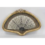 Fan framed behind glass, 20th century, wood and textile, fan struts with flower painting and