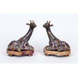 Pair of cloisonné giraffes, China, 19th century (Qing). Reclining giraffes with craned necks.