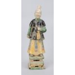 Figure of a woman, China, exact age uncertain. Polychrome painted and glazed. Inlaid head.