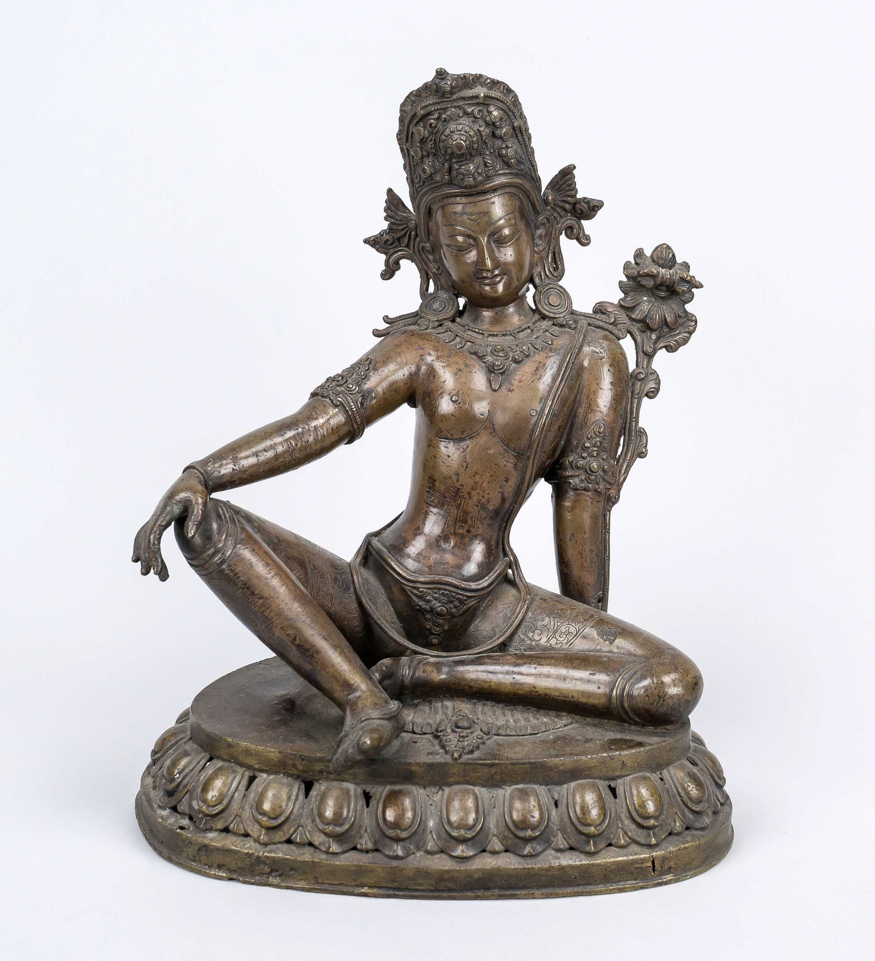 Figure of a saint, Tibet 19th/20th century, bronze. On an openwork lotus base, rubbed & slightly