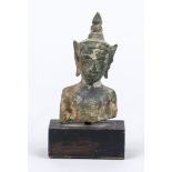 Buddha head/fragment, Southeast Asia, exact age uncertain, bronze. Mounted on a wooden base, h. 10