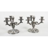 Pair of three-light candlesticks, c. 1900, plated, round base, vase-shaped shaft with cone finial,