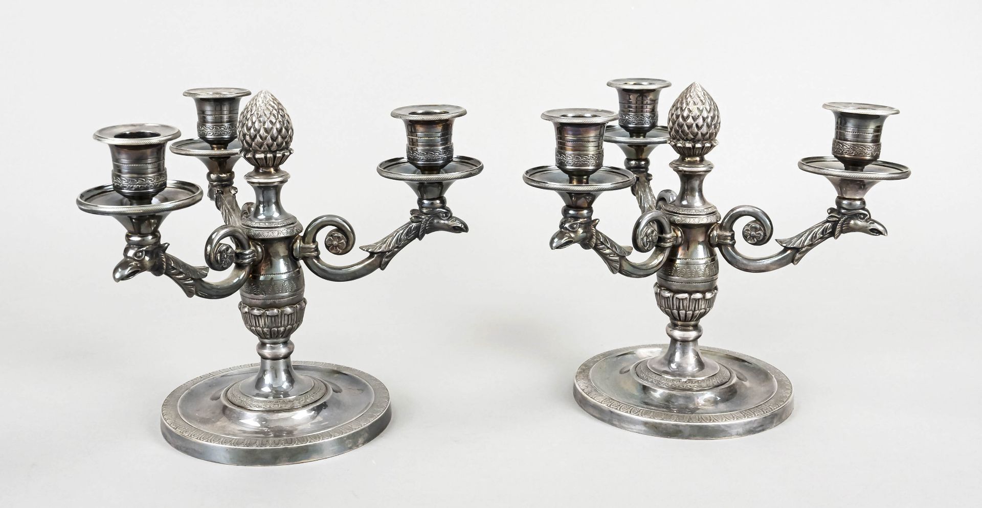 Pair of three-light candlesticks, c. 1900, plated, round base, vase-shaped shaft with cone finial,