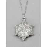 Star-shaped medallion, 19th century, silver tested, hinged, front with sacral, figurative relief