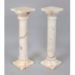 Pair of flower columns, 20th century, light-colored polished stone with natural pattern, smooth