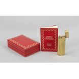 Lighter, France, 20th century, Must de Cartier, Paris, gilt, l. 7 cm, in original case, l. 10.5 cm