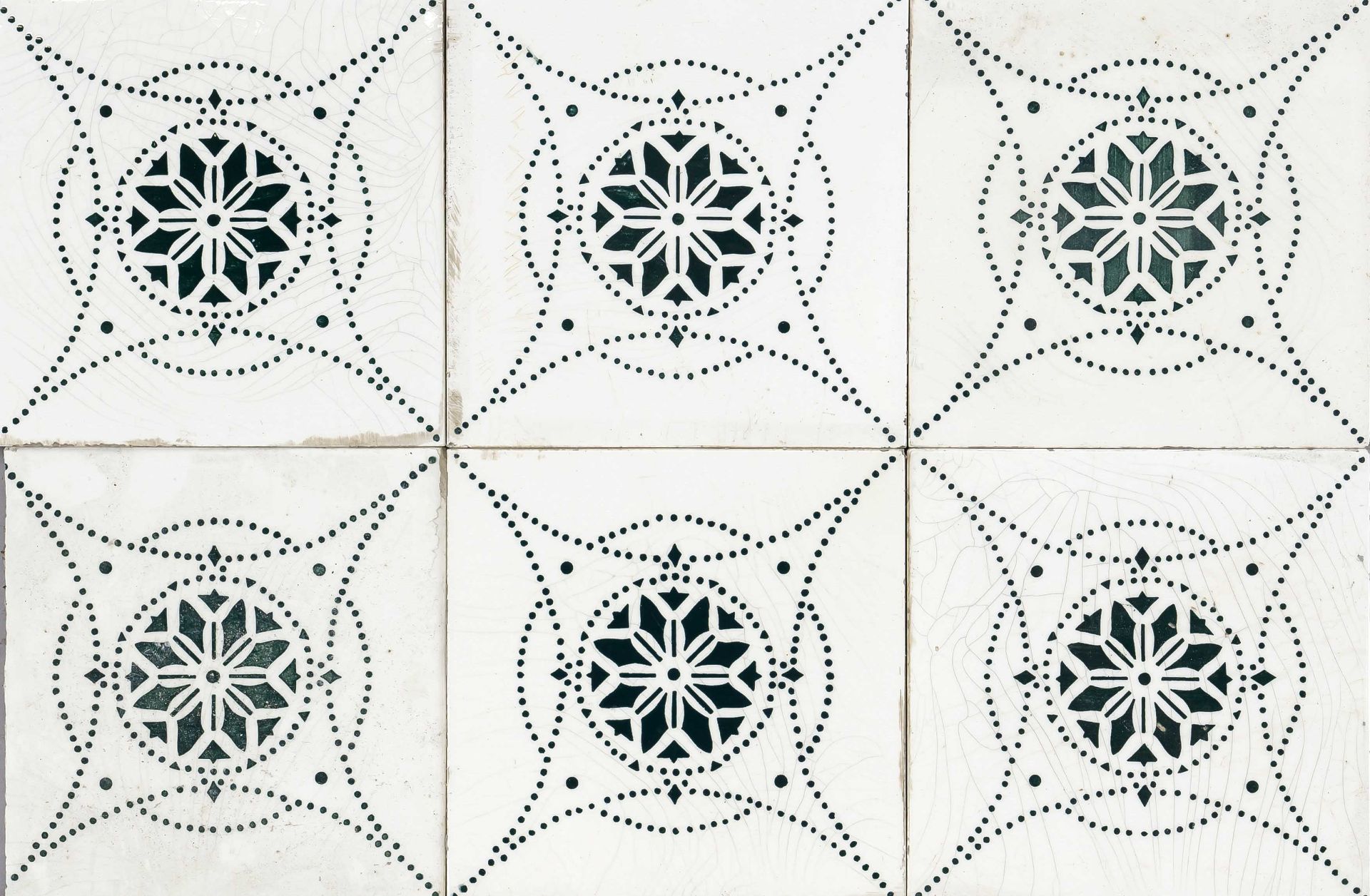 67 Tiles, early 20th century, dark green repeat on a cross star base with stylized flowers, slightly