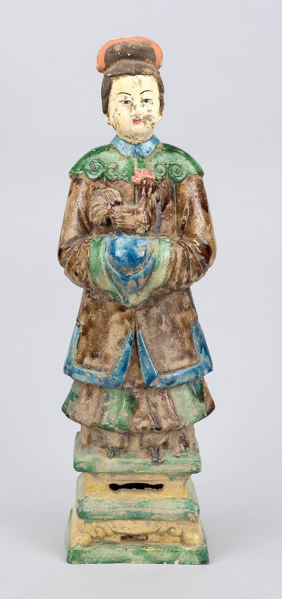Figure of a woman with a rooster on her arm, China, probably Ming period. Polychrome painted and