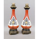 Pair of vase lamps, early 20th century Long-necked vases with various palmettes against an orange