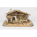 Christmas crib with figures, mid 20th century, wood and plastic. Detailed wooden house with plant