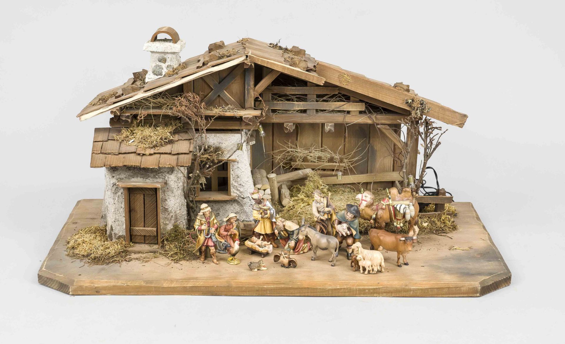 Christmas crib with figures, mid 20th century, wood and plastic. Detailed wooden house with plant