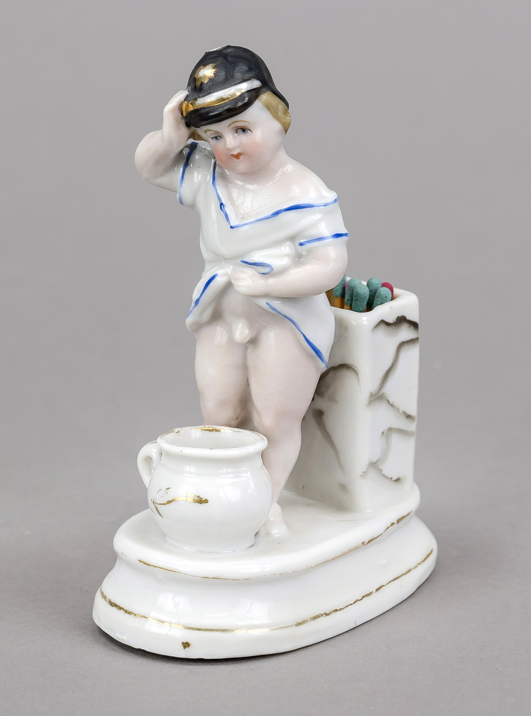 Humorous match holder, late 19th century, polychrome painted and glazed porcelain. A young boy in