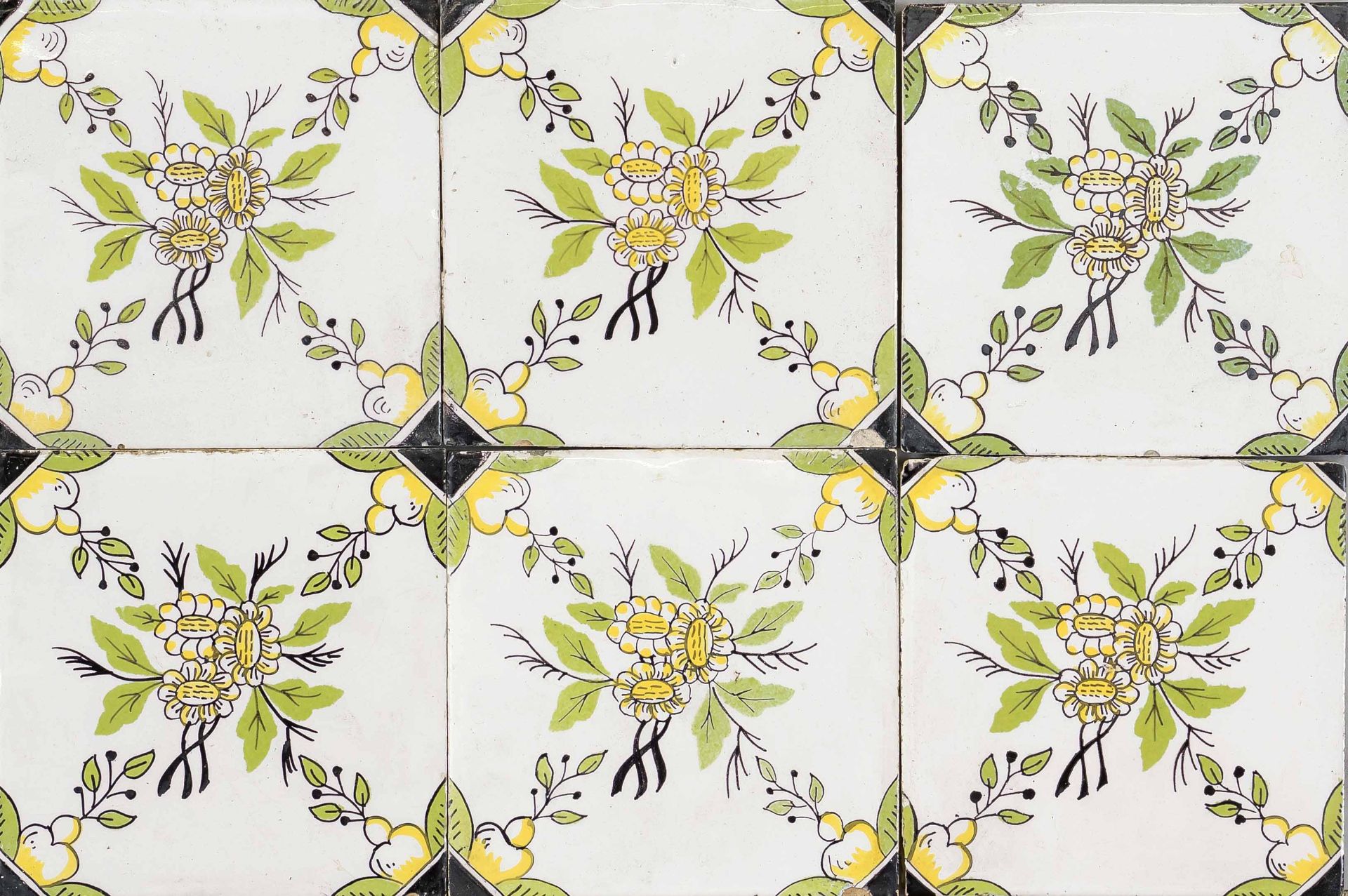 17 tiles, Holland 19th century, polychrome repeat with flower tendrils, slightly rubbed & chipped,