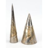 Pair of sculptures, pointed cone objects, clay covered with metal segments, signed and dated Roy